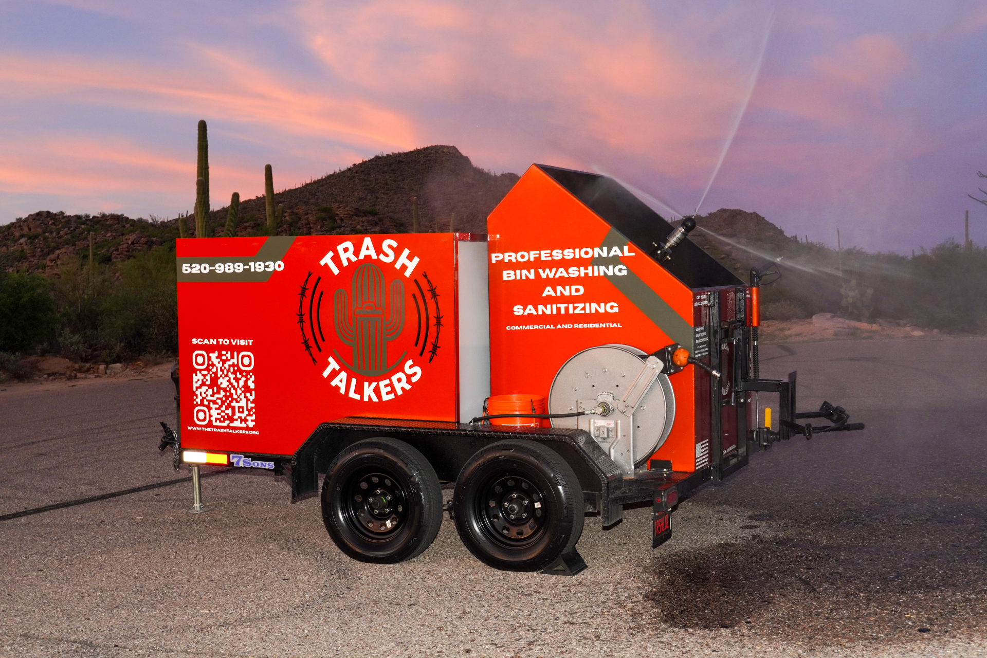 Crush orange The Trash Talkers bin cleaning trailer spraying water in the Sonoran Desert near Tucson